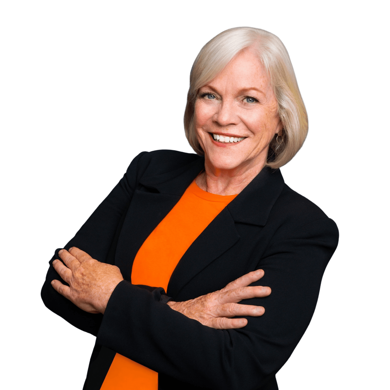 Dr. Anne Kenny, host of the Caregiver Storyteller podcast in English, wearing a black blazer and orange shirt.