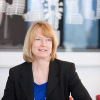 Woman in blazer in an office setting
